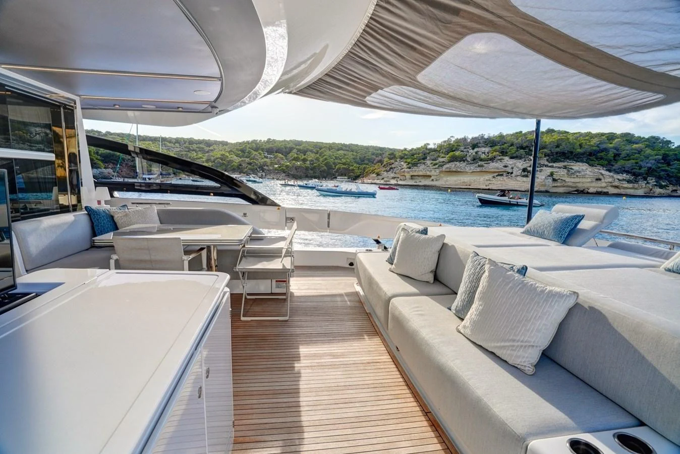 The aft deck features a spacious lounging area with comfortable seating and a scenic view of the water. aboard APRICITY Yacht for Sale