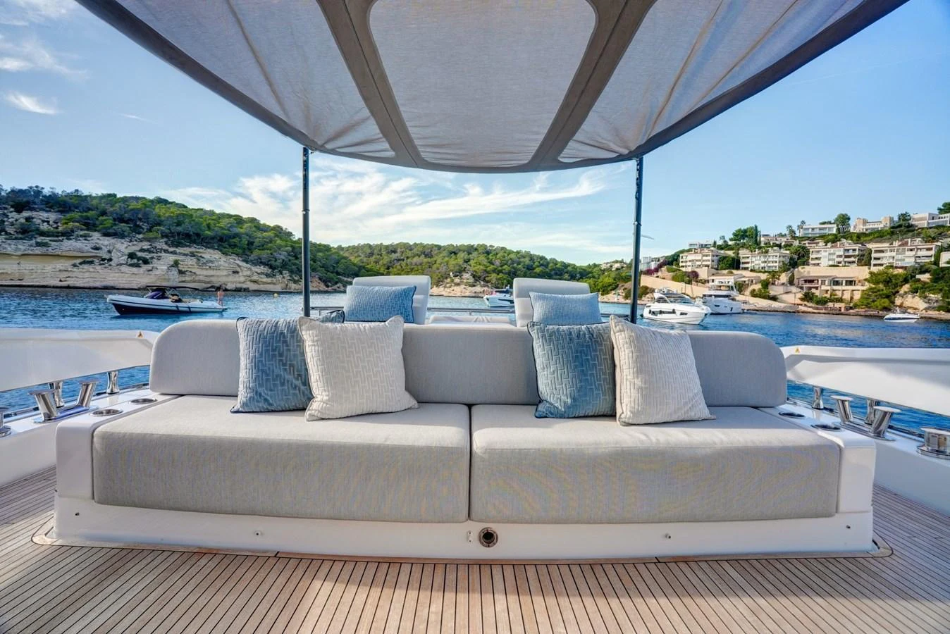 The sundeck offers a comfortable seating area with a canopy providing shade and scenic views of the surrounding waters. aboard APRICITY Yacht for Sale