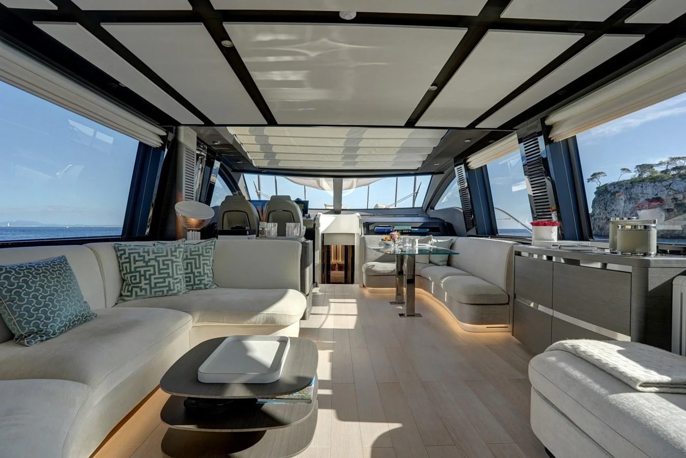 The yacht's salon features modern furnishings and expansive windows offering panoramic views. aboard APRICITY Yacht for Sale