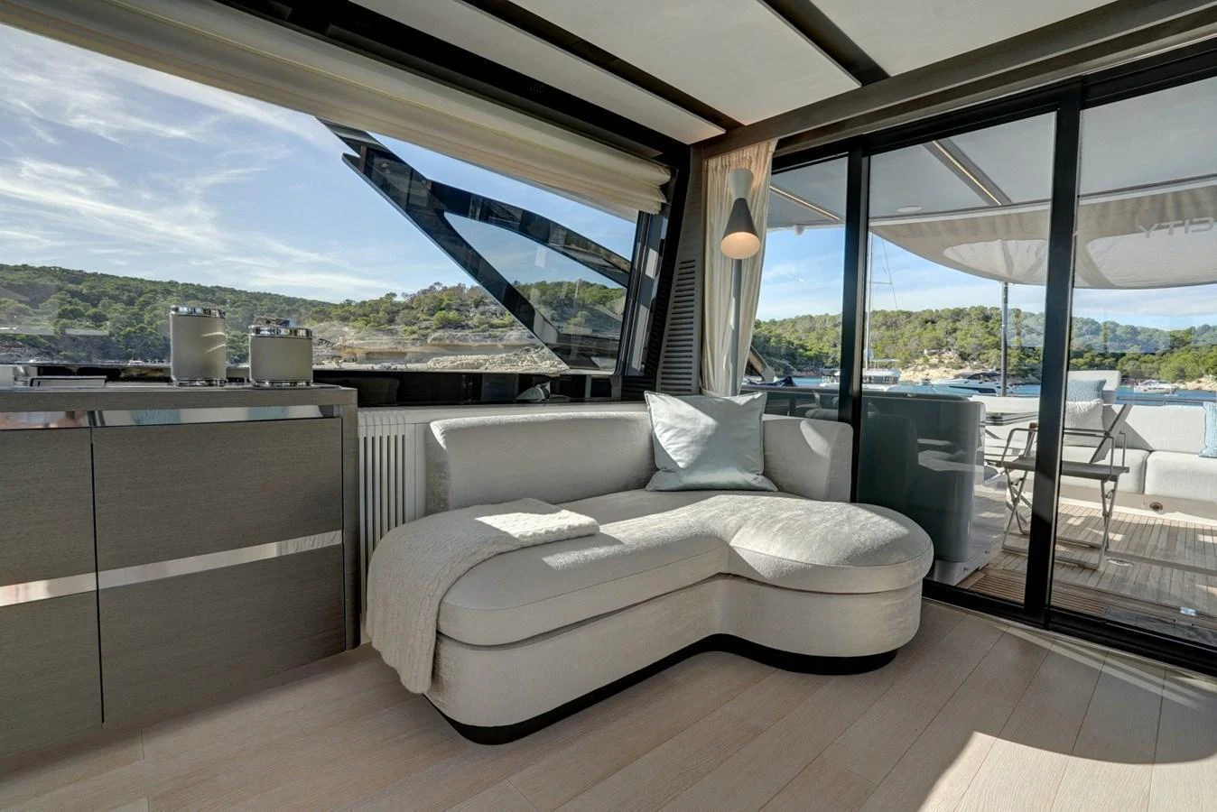 The salon offers a comfortable and stylish seating area with a view of the surrounding waters. aboard APRICITY Yacht for Sale