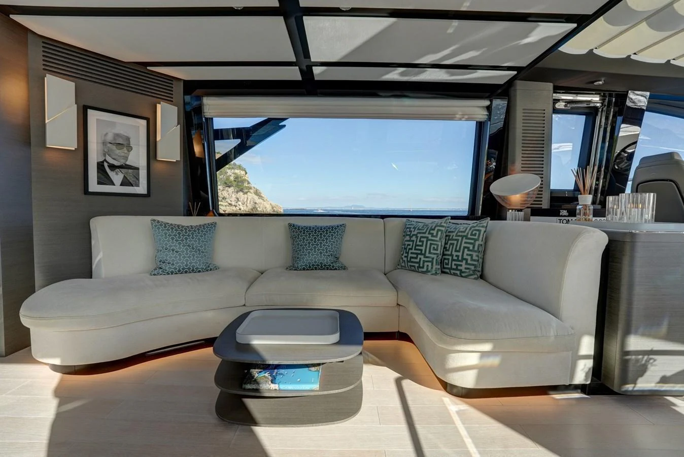 The salon features a luxurious seating area with a large window offering stunning views. aboard APRICITY Yacht for Sale