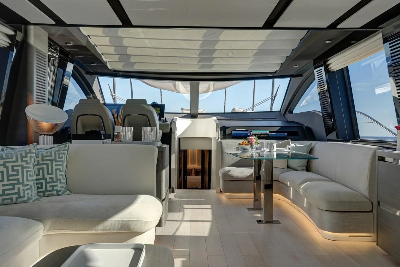 The salon offers a spacious and modern seating area with ample natural light and elegant furnishings. aboard APRICITY Yacht for Sale