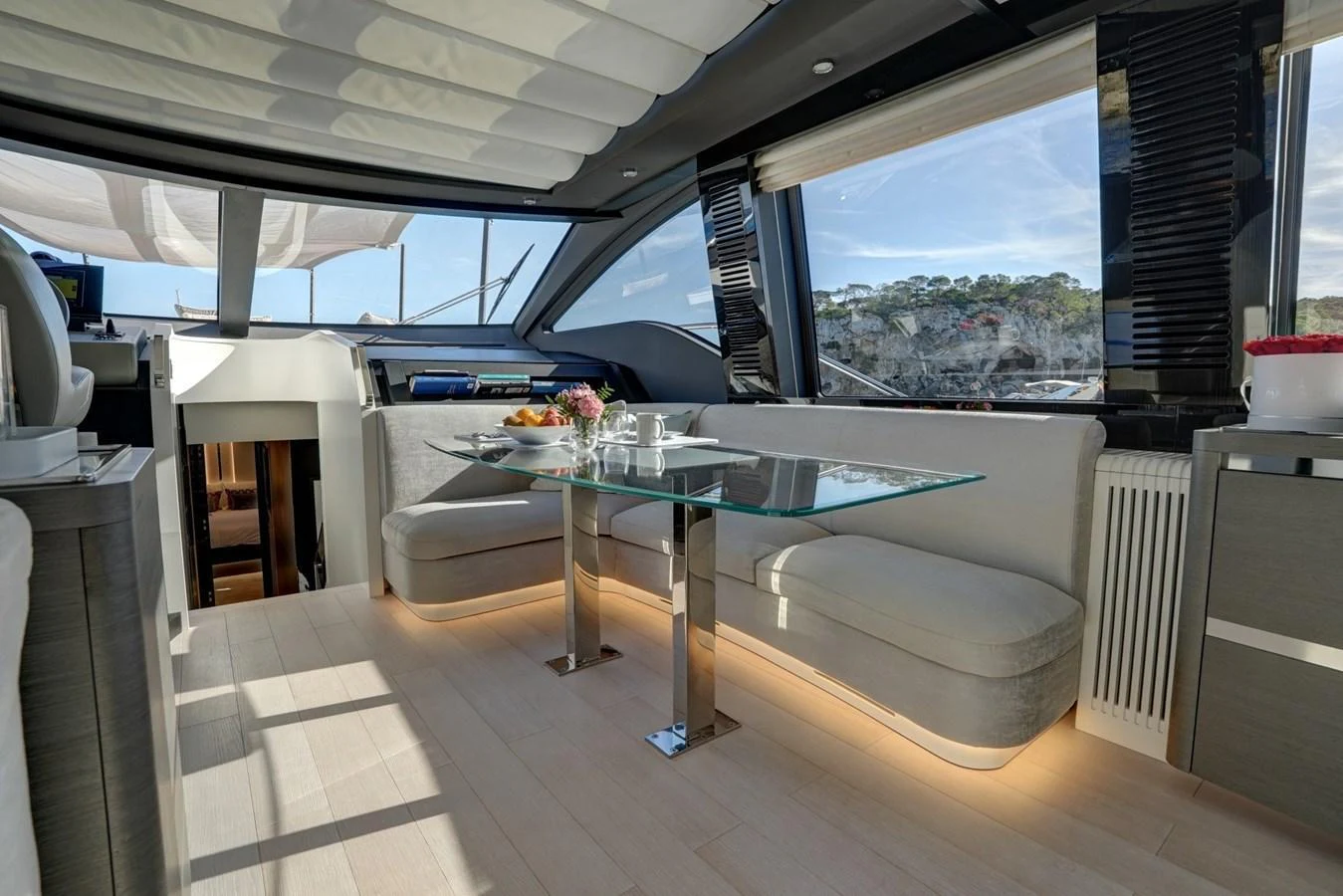 The yacht's salon features a modern and elegant dining area with panoramic windows. aboard APRICITY Yacht for Sale