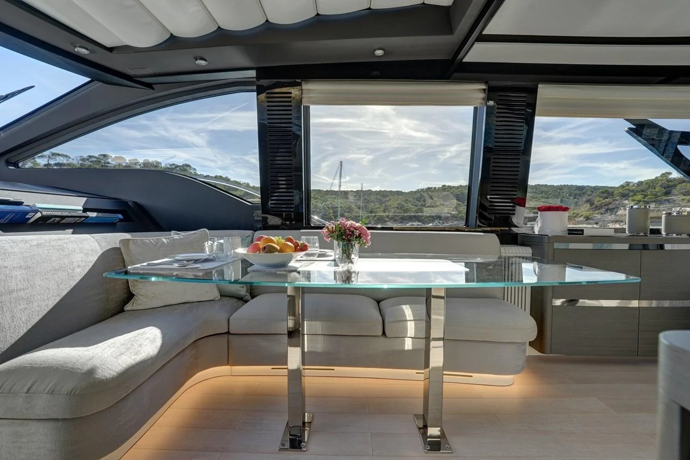 The salon features a modern and elegant dining area with panoramic views. aboard APRICITY Yacht for Sale