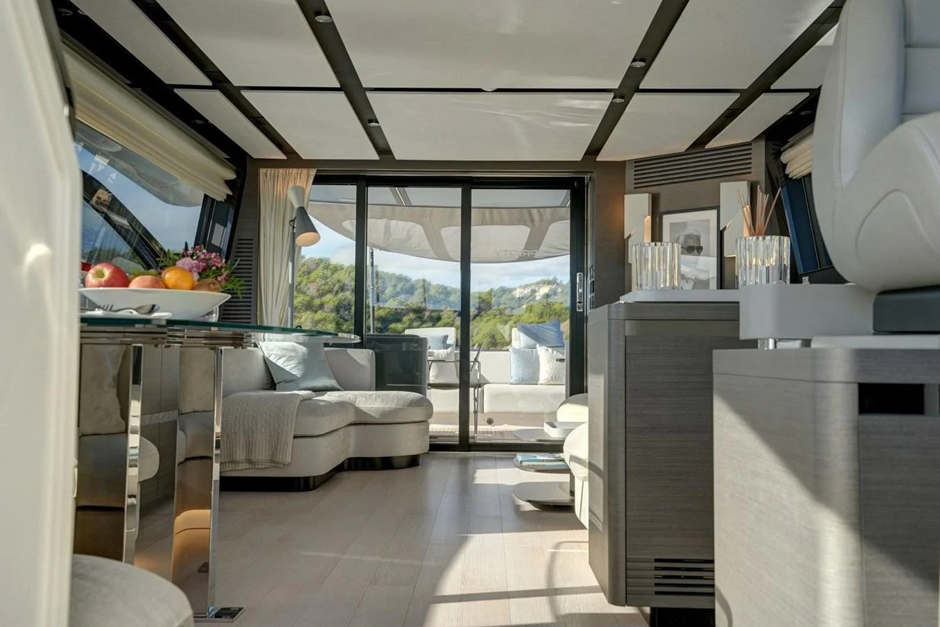 The salon offers a spacious and elegantly designed area with ample natural light and luxurious furnishings. aboard APRICITY Yacht for Sale