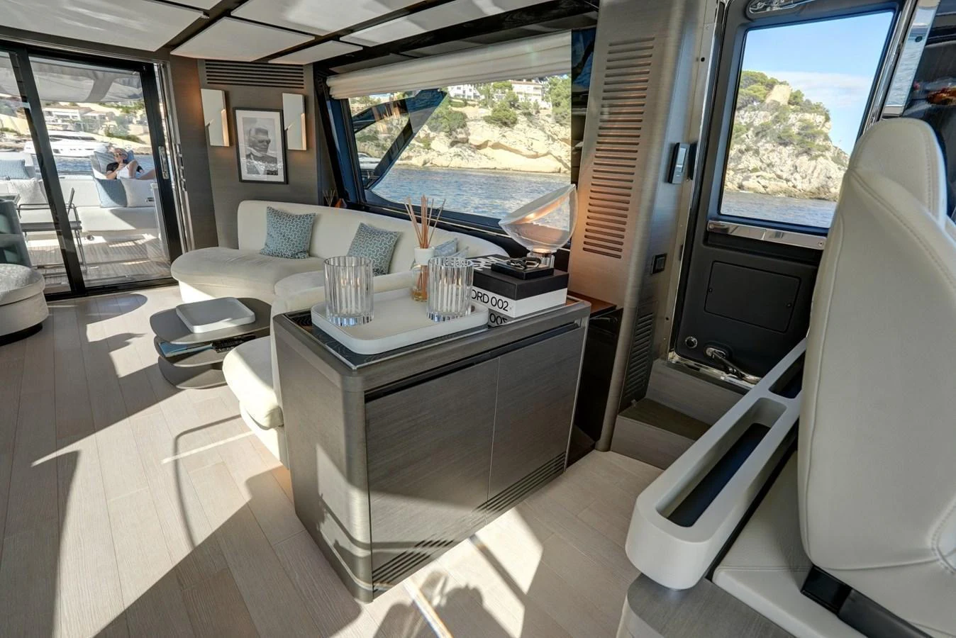 The yacht's interior features a modern and elegant living area with large windows offering scenic views. aboard APRICITY Yacht for Sale