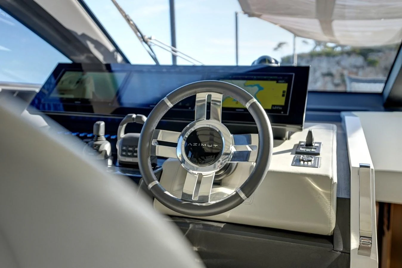 The helm station features a sleek, modern steering wheel and advanced navigation equipment. aboard APRICITY Yacht for Sale