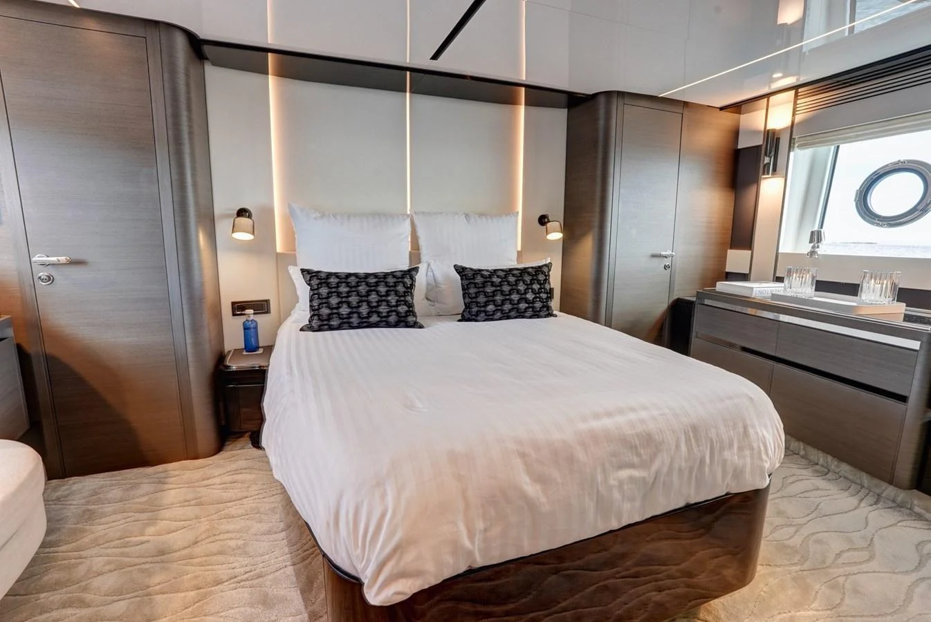 A luxurious stateroom featuring a comfortable bed with elegant bedding and modern furnishings. aboard APRICITY Yacht for Sale