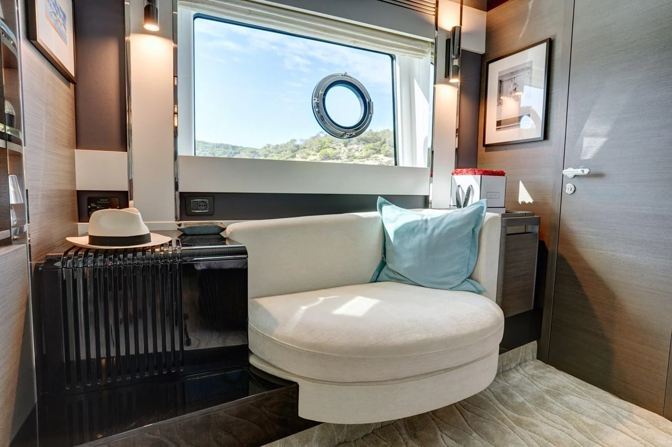 A cozy interior seating area with a window view, perfect for relaxation. aboard APRICITY Yacht for Sale
