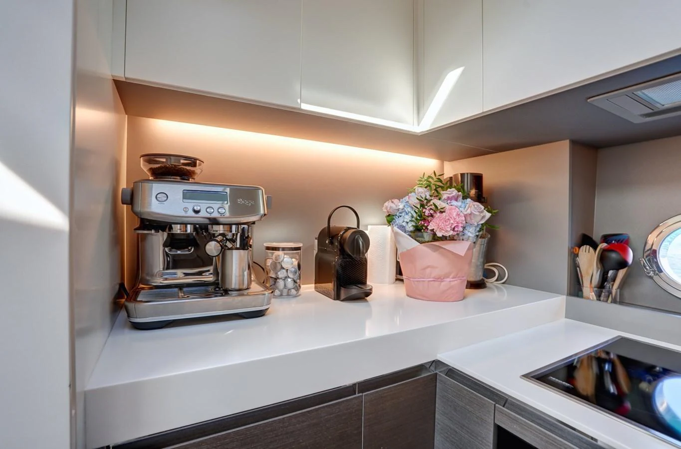 The yacht's galley features a modern coffee machine and stylish decor, creating a cozy and functional space. aboard APRICITY Yacht for Sale