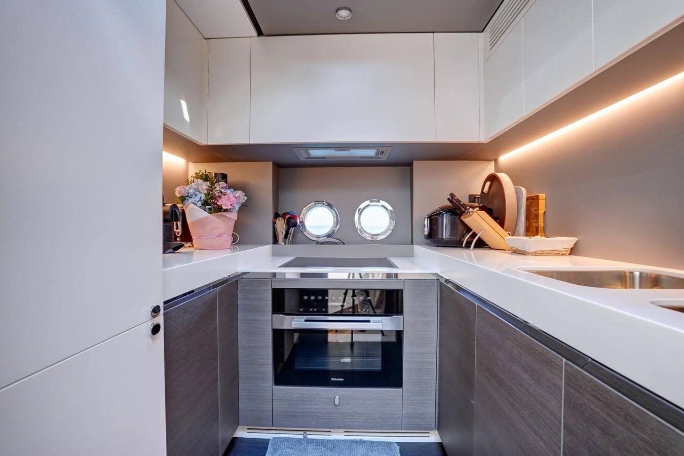 The yacht's galley is modern and well-equipped, featuring sleek cabinetry and ample counter space. aboard APRICITY Yacht for Sale