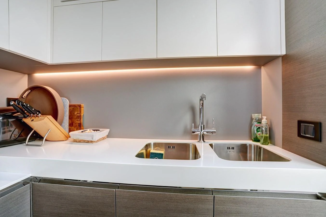 The modern galley features sleek cabinetry, dual sinks, and under-cabinet lighting. aboard APRICITY Yacht for Sale