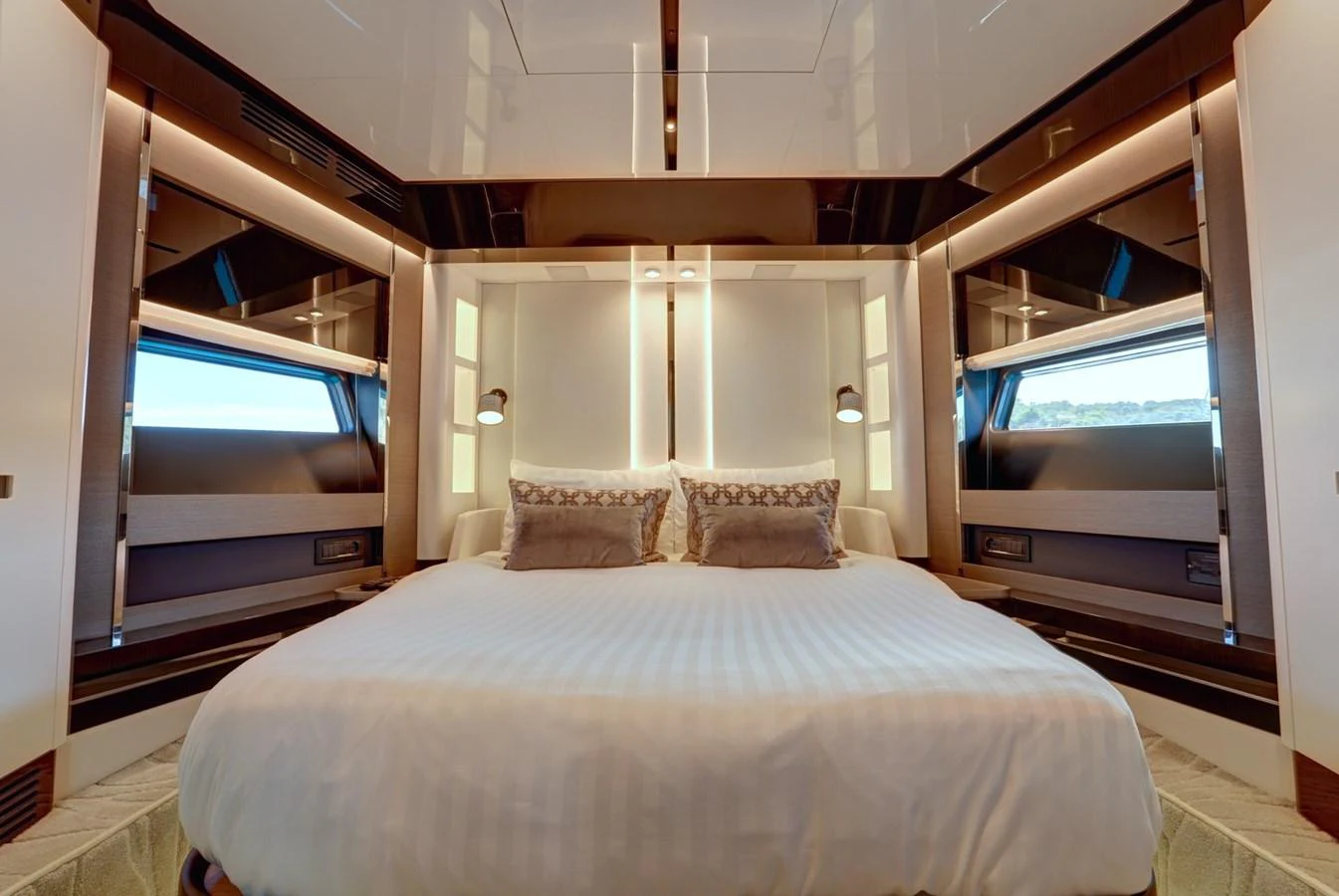 The stateroom features a luxurious bed with elegant lighting and modern design elements. aboard APRICITY Yacht for Sale