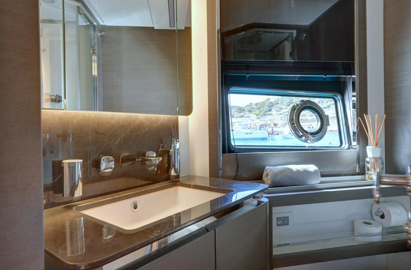 The yacht's bathroom features a sleek design with modern fixtures and a scenic window view. aboard APRICITY Yacht for Sale