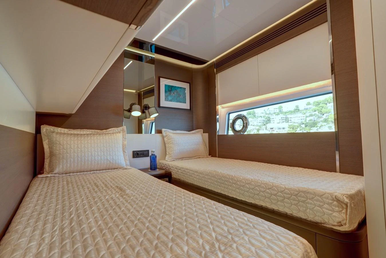 The twin stateroom offers a cozy and inviting space with two single beds and modern decor. aboard APRICITY Yacht for Sale