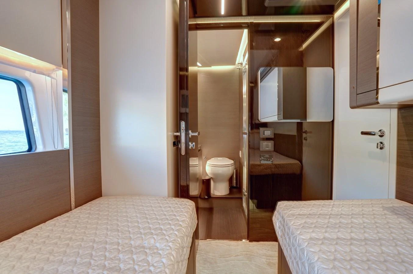 The guest cabin features twin beds and an ensuite bathroom, offering comfort and privacy. aboard APRICITY Yacht for Sale