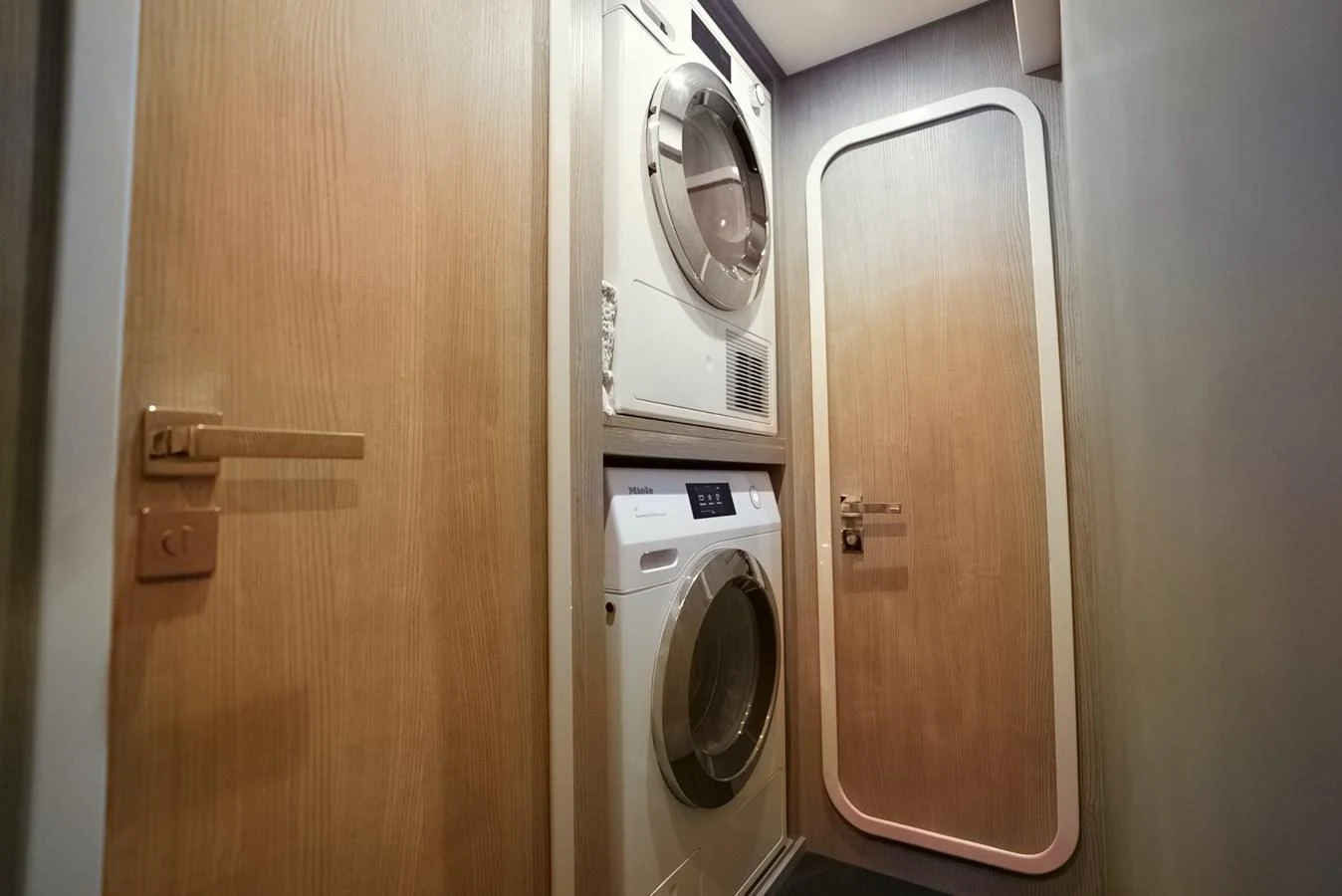 The yacht features a practical laundry room with modern appliances. aboard APRICITY Yacht for Sale