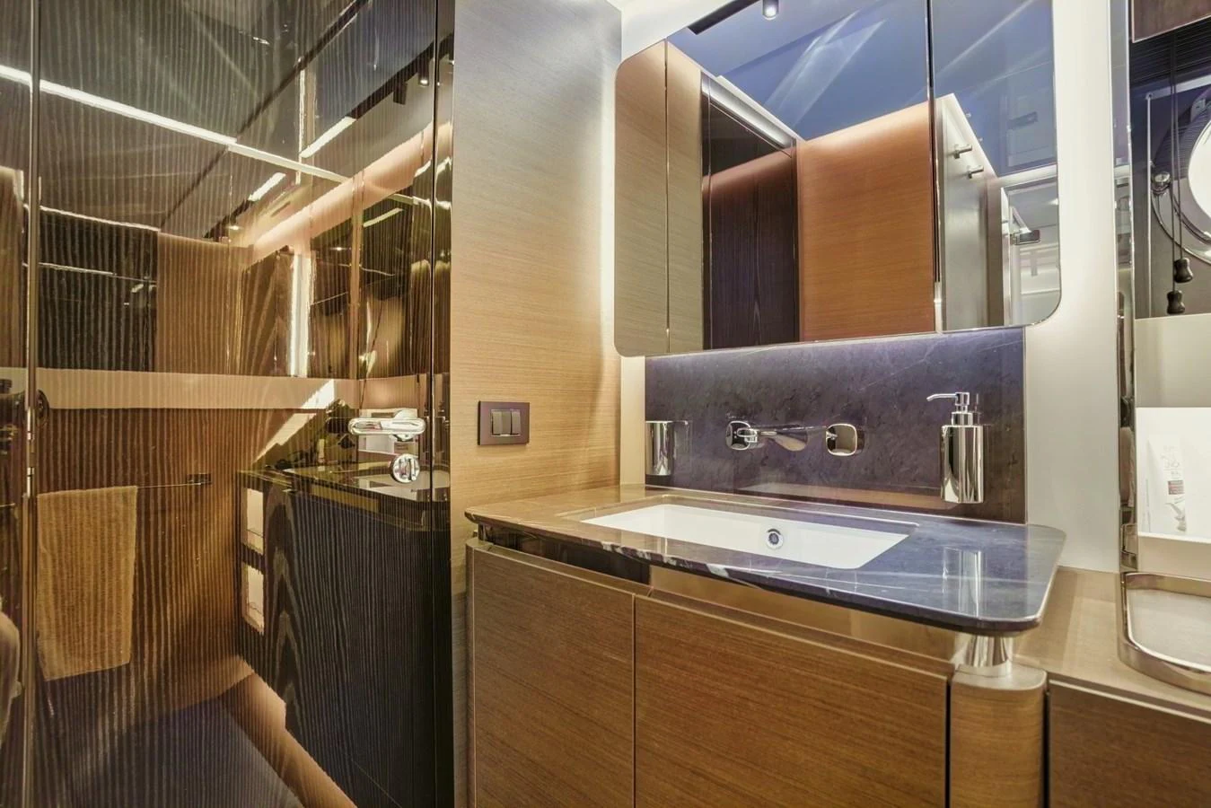 The yacht's bathroom features modern fixtures and a sleek design with ample lighting. aboard APRICITY Yacht for Sale