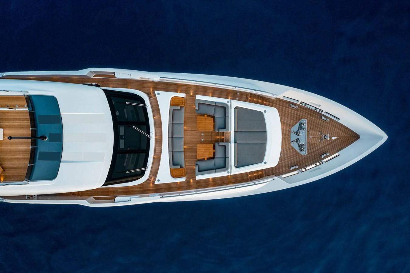 The yacht's foredeck features a spacious sunbathing area with luxurious seating and a sleek design. aboard MIOTU Yacht for Sale