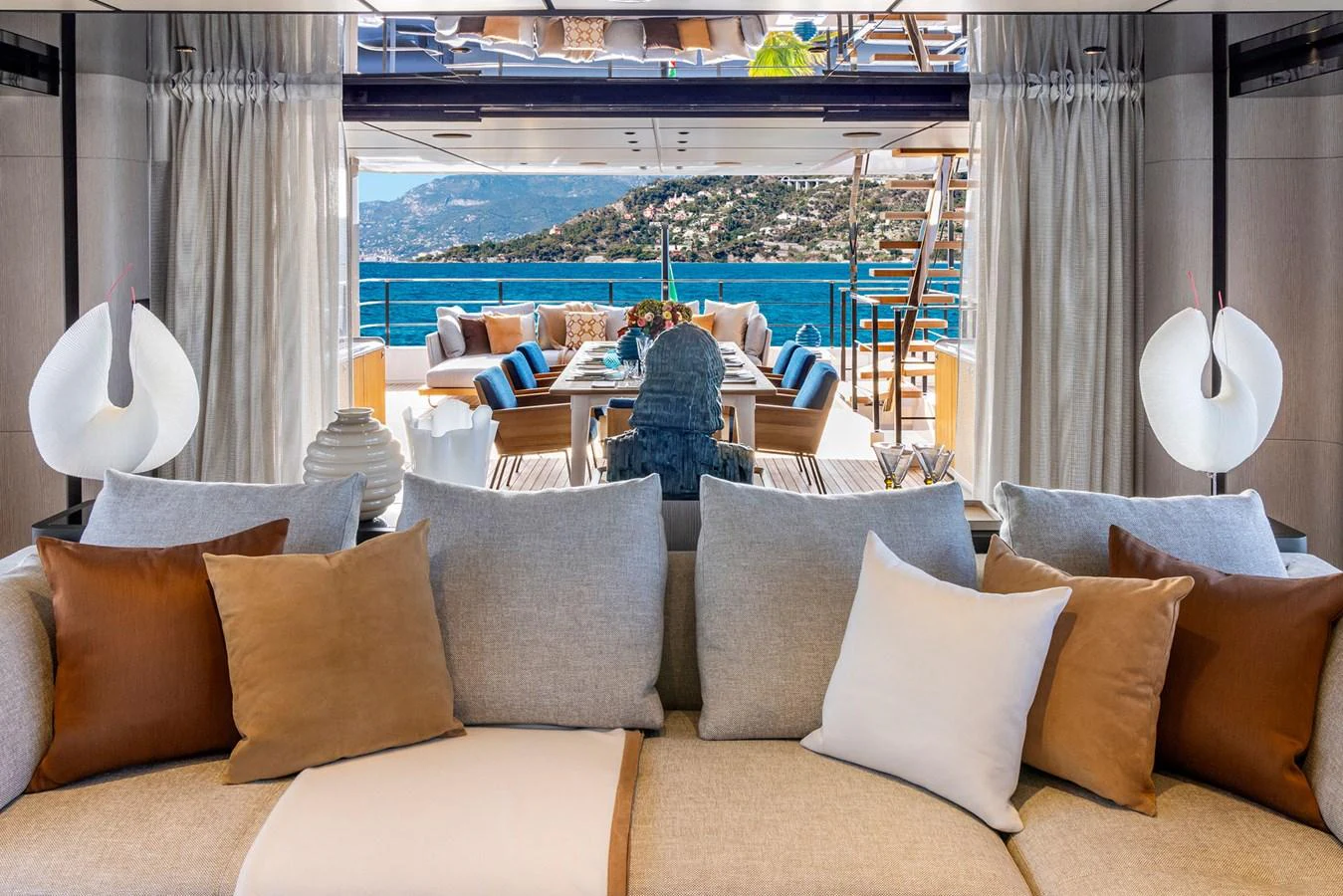 The salon offers a luxurious and inviting space with a stunning view of the aft deck and the sea beyond. aboard MIOTU Yacht for Sale