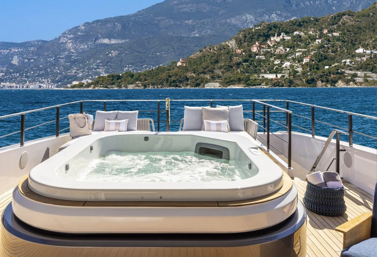 The sundeck features a luxurious hot tub with stunning views of the surrounding landscape. aboard MIOTU Yacht for Sale