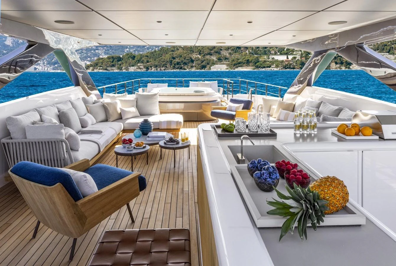 The aft deck offers a luxurious outdoor living space with comfortable seating and a well-appointed bar area, perfect for entertaining while enjoying scenic views. aboard MIOTU Yacht for Sale