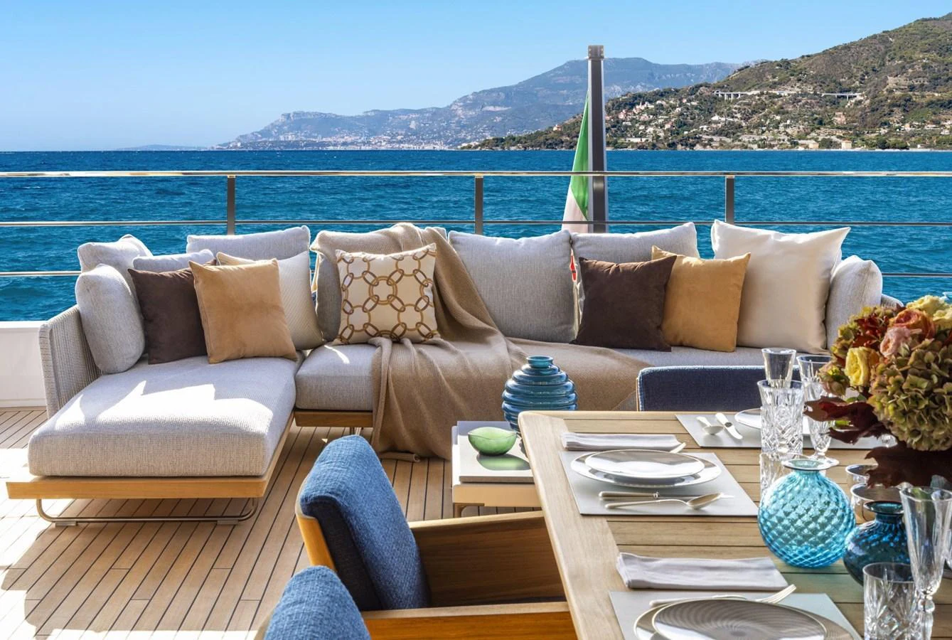 The aft deck features a comfortable seating area with a stunning ocean view. aboard MIOTU Yacht for Sale