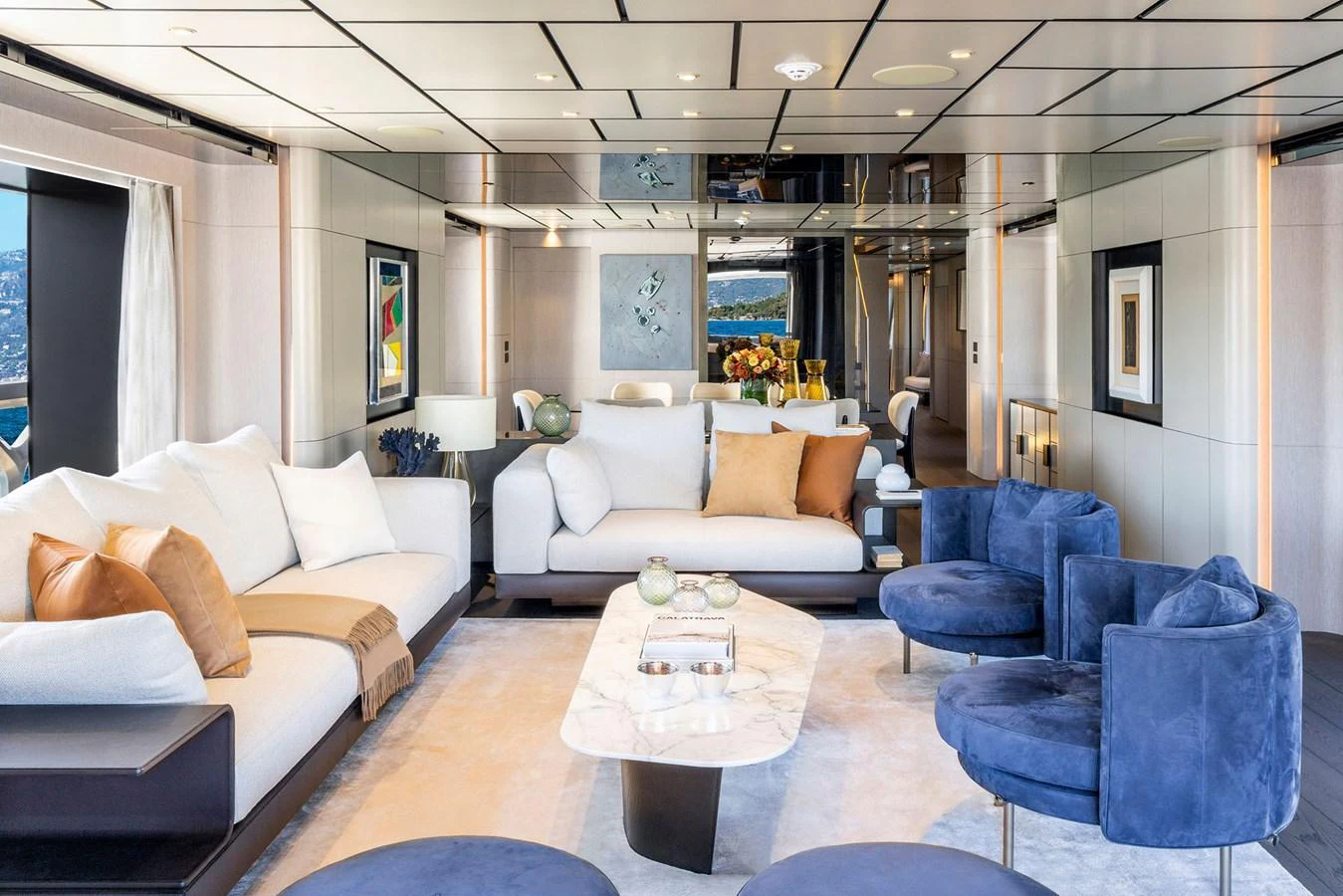 The salon features luxurious seating with a modern design and ample natural light. aboard MIOTU Yacht for Sale