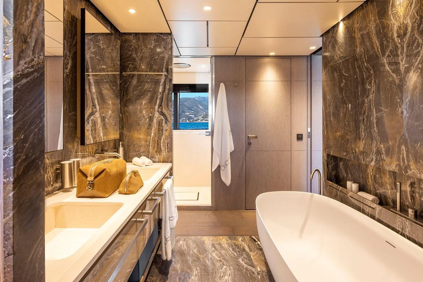 Luxurious bathroom with elegant marble finishes and a freestanding bathtub. aboard MIOTU Yacht for Sale