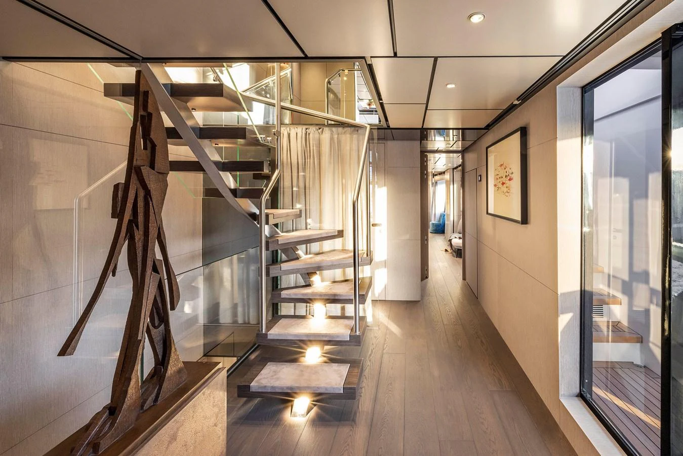 The yacht's interior features a modern staircase with elegant lighting and contemporary decor. aboard MIOTU Yacht for Sale