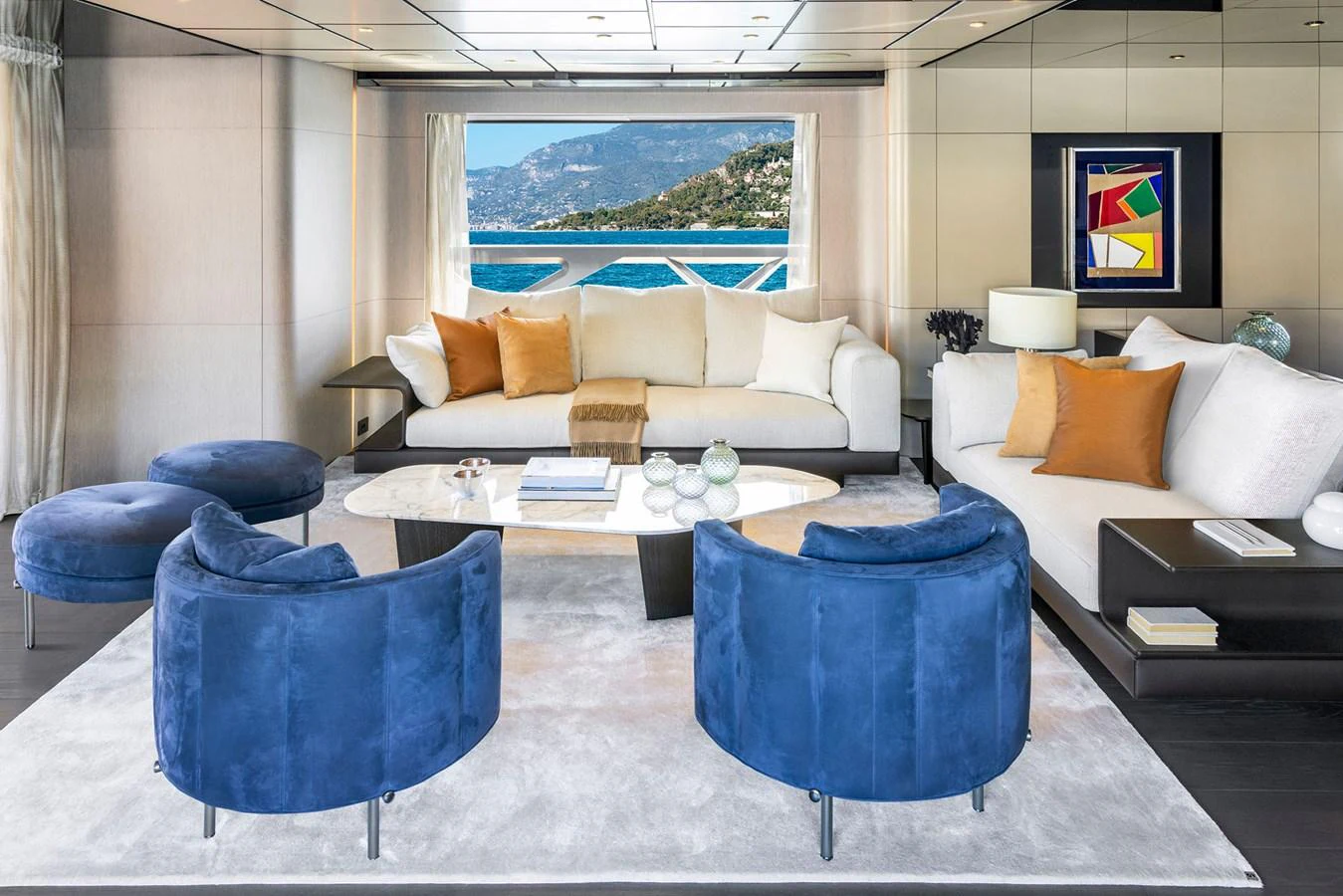 The salon features luxurious seating with a stunning view of the sea. aboard MIOTU Yacht for Sale
