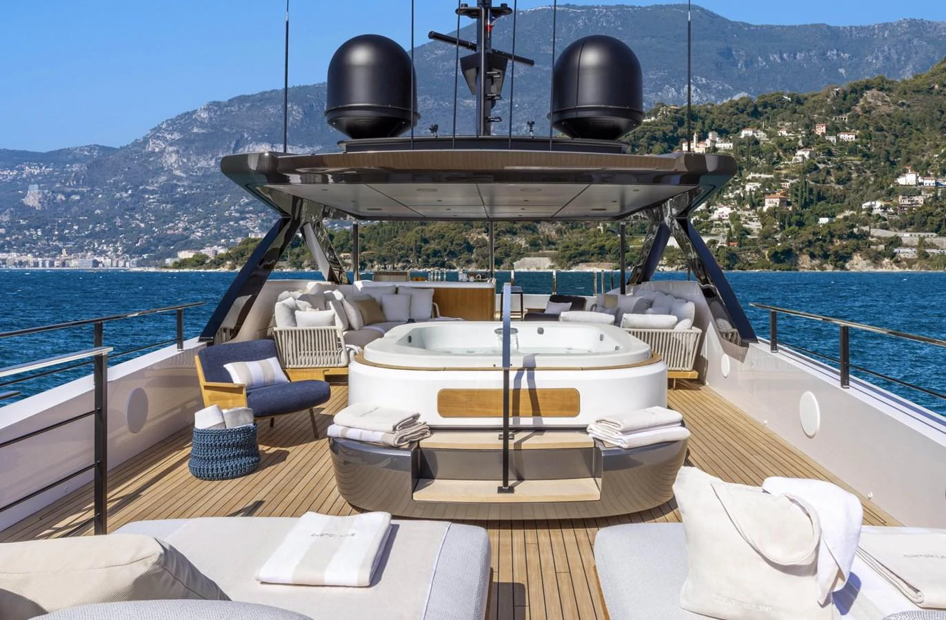 The sundeck features a luxurious hot tub surrounded by comfortable lounging areas, offering stunning views of the coastline. aboard MIOTU Yacht for Sale