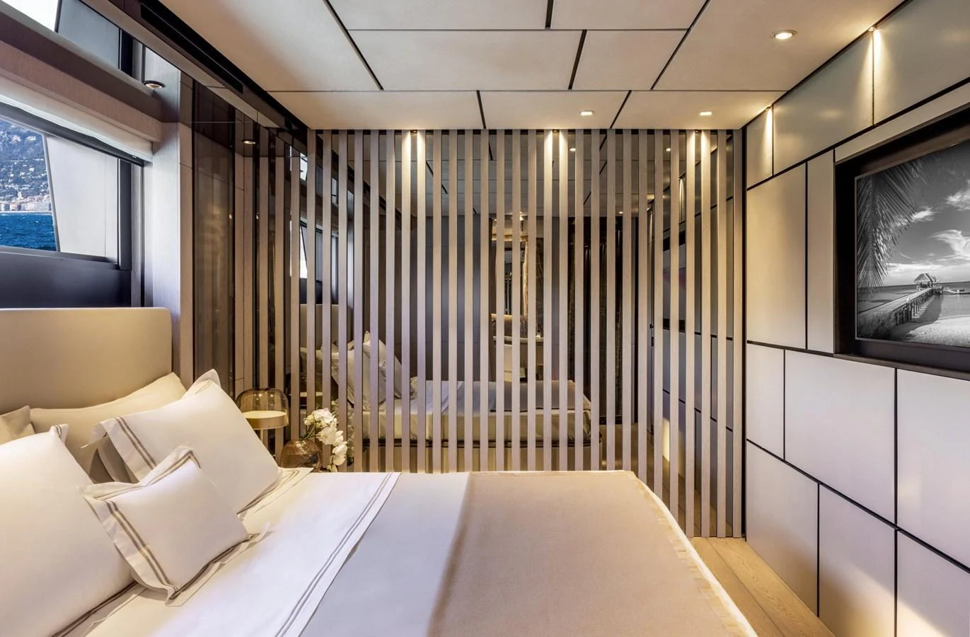 The stateroom features a luxurious bed with elegant linens and a modern, sophisticated design. aboard MIOTU Yacht for Sale