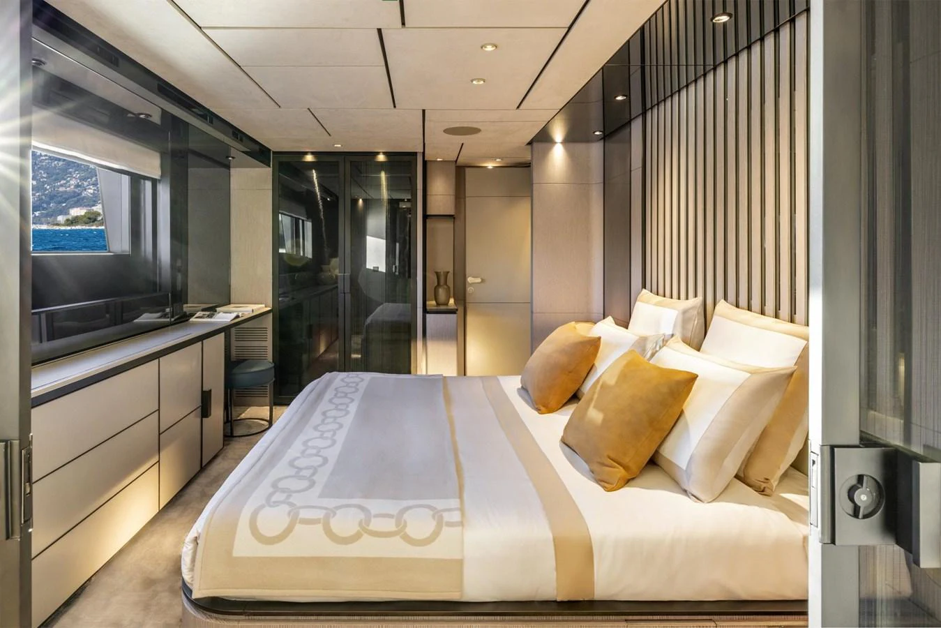 The master stateroom features a luxurious bed with elegant decor and ample natural light. aboard MIOTU Yacht for Sale