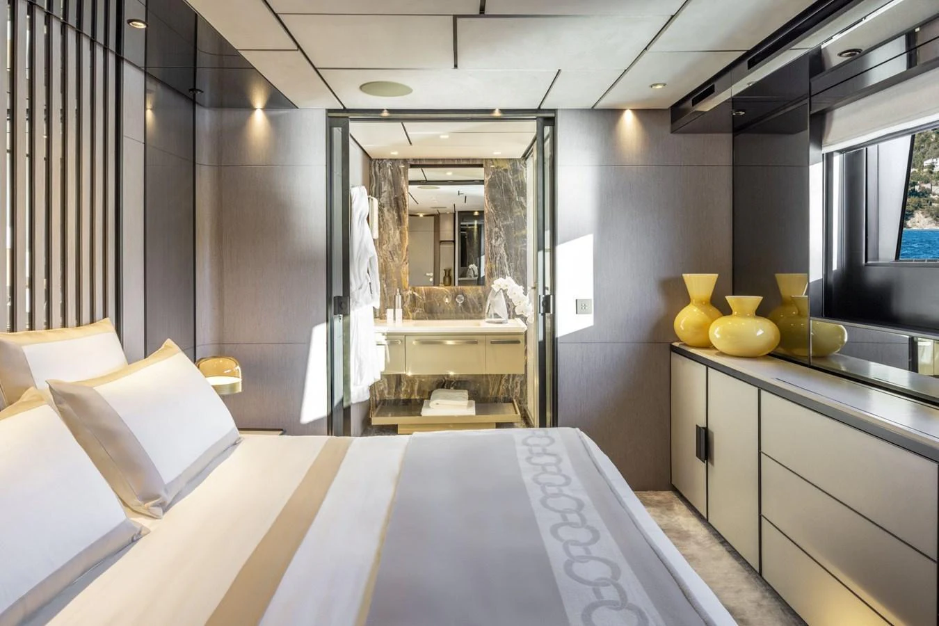 The master stateroom features a luxurious bed, modern decor, and an en-suite bathroom with elegant finishes. aboard MIOTU Yacht for Sale