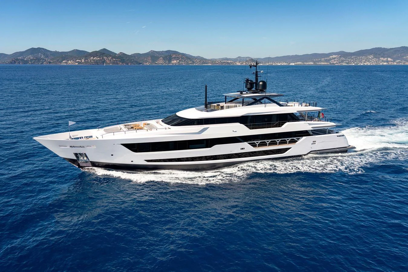 A sleek and modern yacht cruises through the open sea, showcasing its elegant design and luxurious build. aboard MIOTU Yacht for Sale
