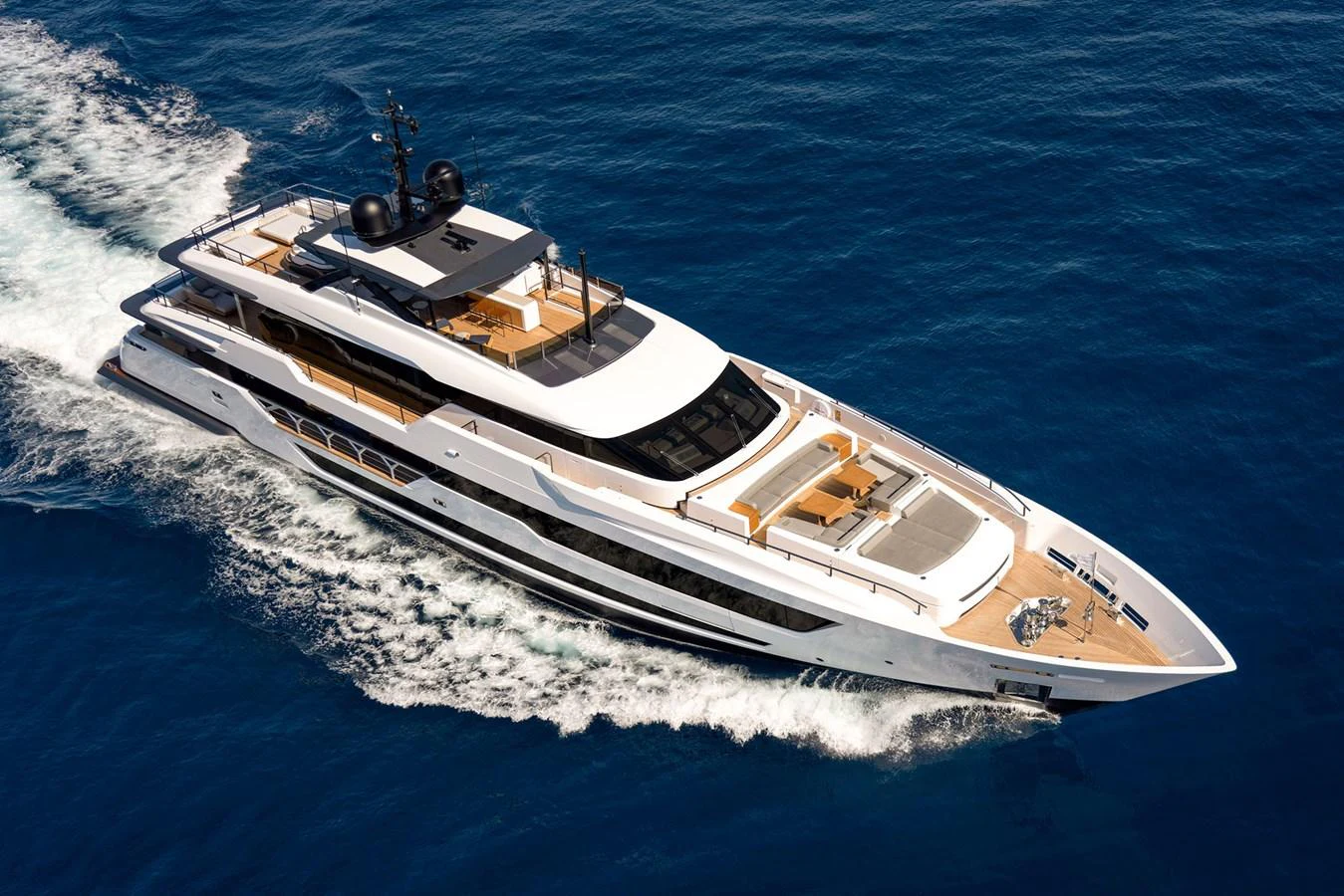 A sleek and modern yacht cruises through the open sea, showcasing its luxurious design and spacious decks. aboard MIOTU Yacht for Sale