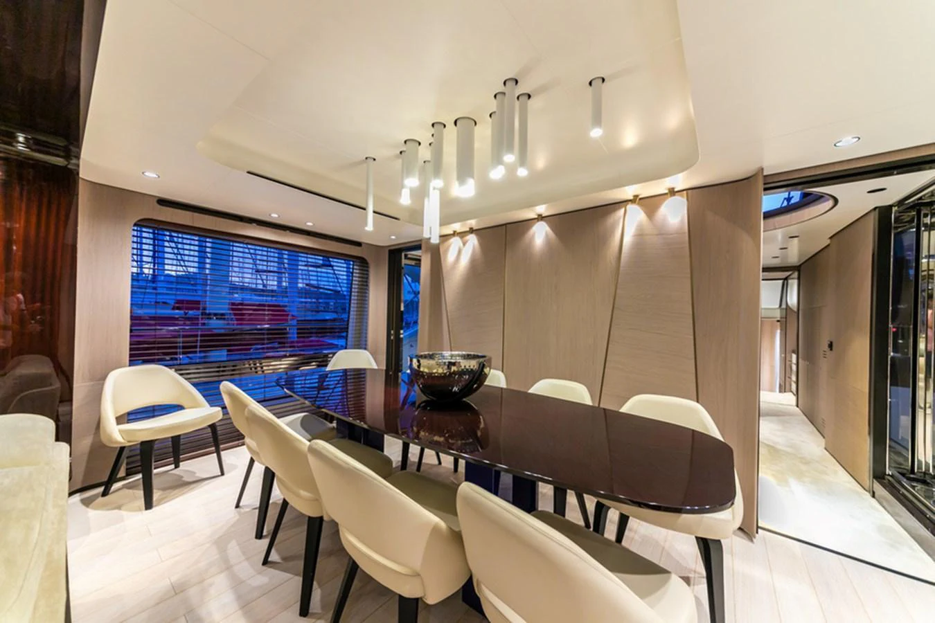 The yacht's dining area features a sleek, modern design with ample seating and elegant lighting. aboard NIRVANA BY THE SEA Yacht for Sale