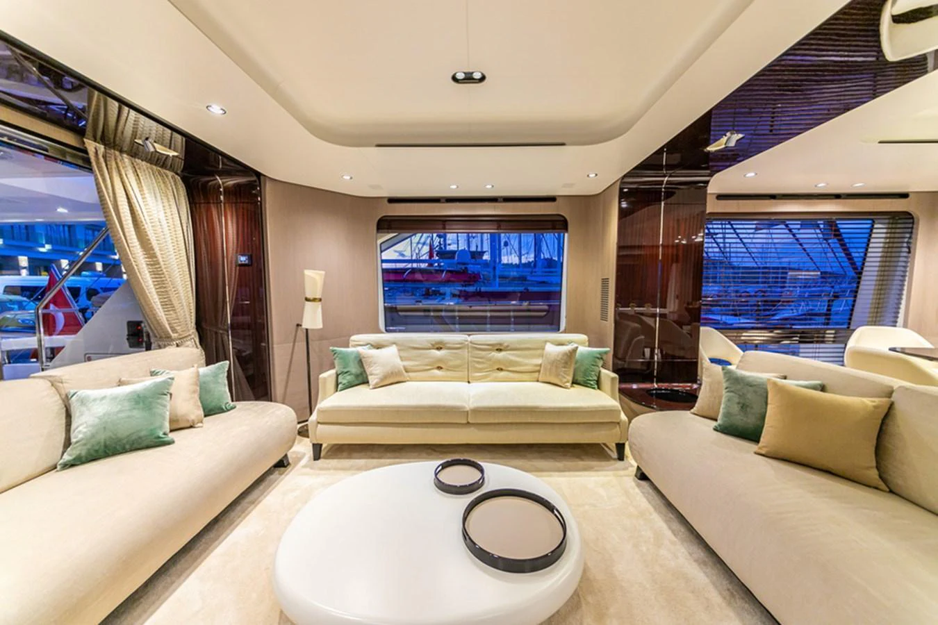 The salon features luxurious seating with elegant decor and ample natural light. aboard NIRVANA BY THE SEA Yacht for Sale