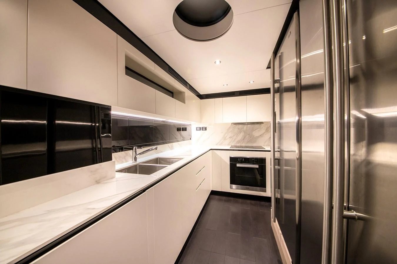 The sleek and modern galley features high-end appliances and ample counter space. aboard NIRVANA BY THE SEA Yacht for Sale