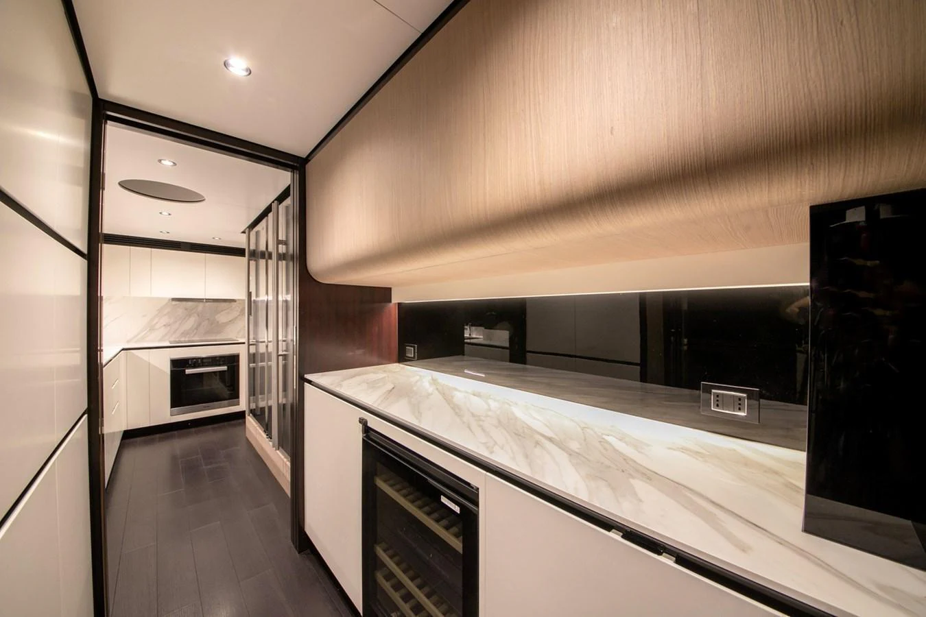 The galley features modern appliances and sleek surfaces, perfect for gourmet cooking. aboard NIRVANA BY THE SEA Yacht for Sale