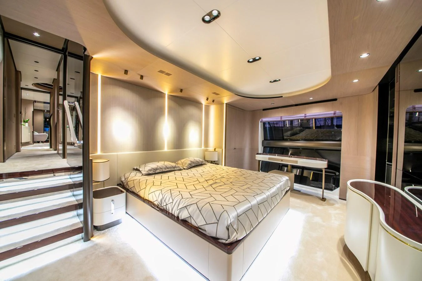 The master stateroom features a luxurious bed with modern lighting and elegant design. aboard NIRVANA BY THE SEA Yacht for Sale