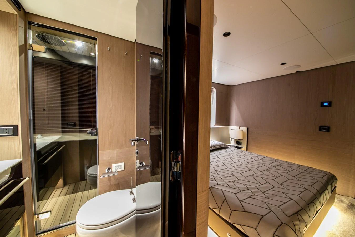 A luxurious stateroom with an ensuite bathroom, featuring modern design and warm lighting. aboard NIRVANA BY THE SEA Yacht for Sale