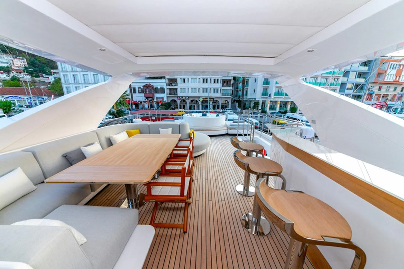 The flybridge offers a spacious and elegant area for dining and relaxation with a stunning view of the surroundings. aboard NIRVANA BY THE SEA Yacht for Sale