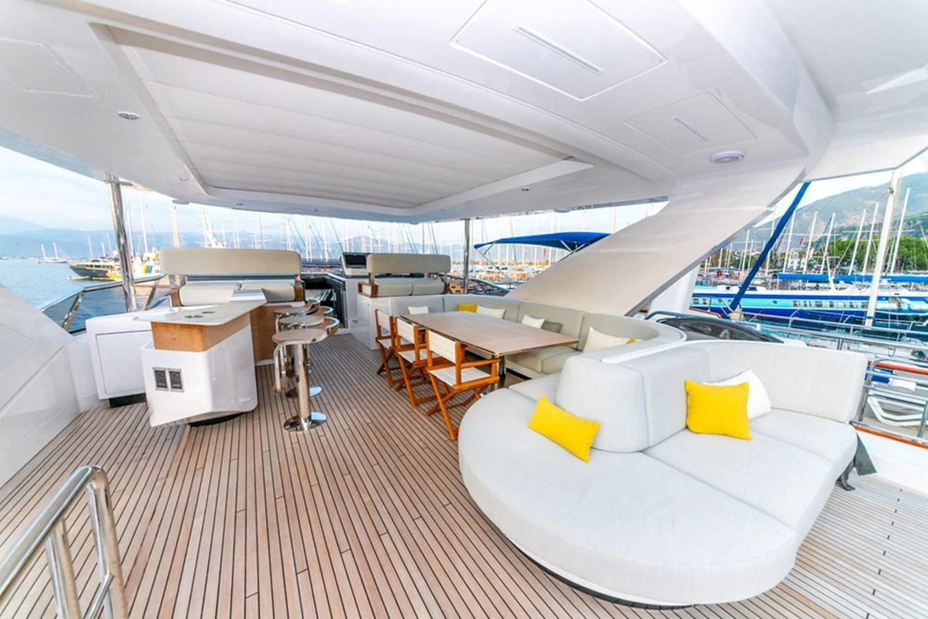The aft deck features luxurious seating and dining areas with a stunning view of the marina. aboard NIRVANA BY THE SEA Yacht for Sale
