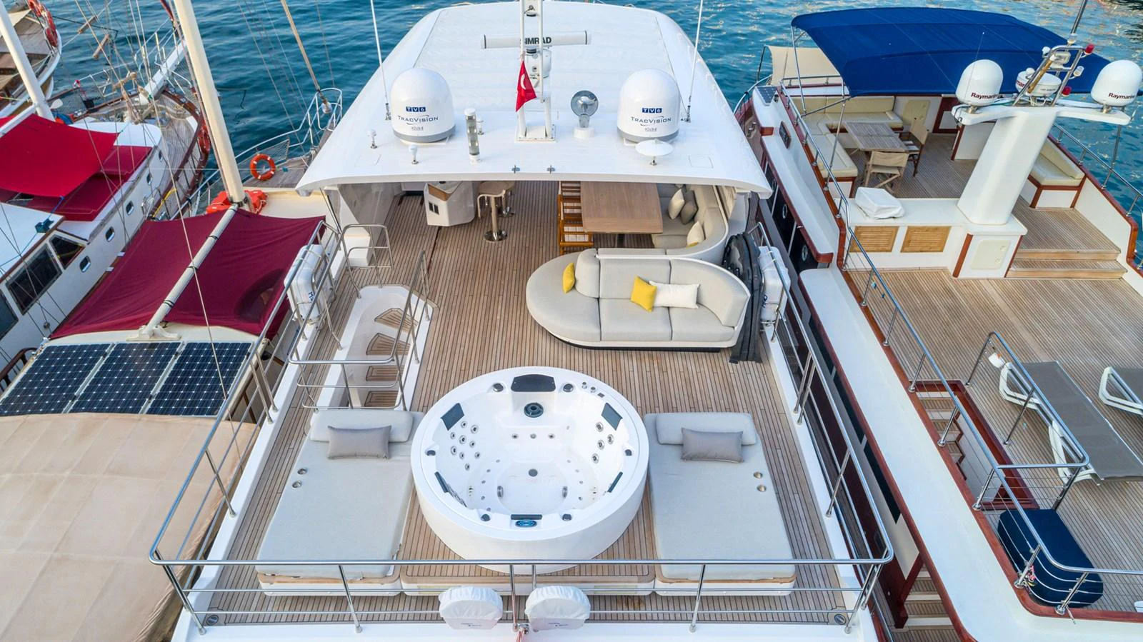 The sundeck features a luxurious hot tub, ample seating, and a shaded lounge area. aboard NIRVANA BY THE SEA Yacht for Sale