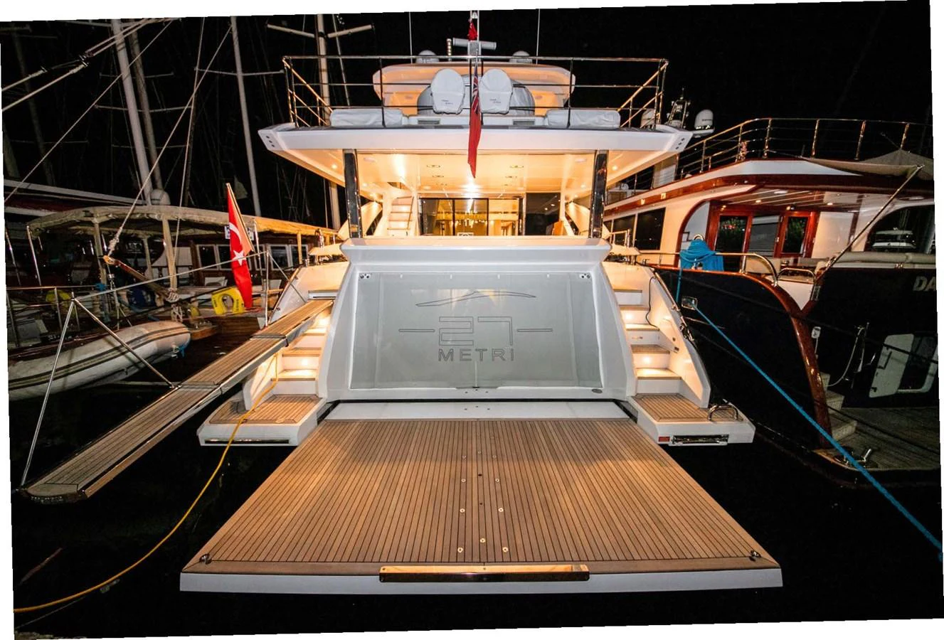 The yacht's aft deck is beautifully illuminated, showcasing a spacious and inviting area for relaxation and entertainment. aboard NIRVANA BY THE SEA Yacht for Sale