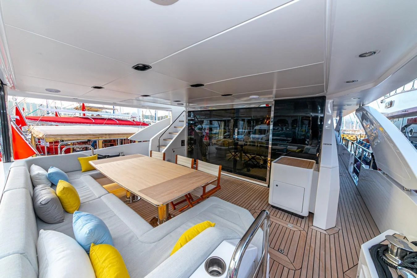 The aft deck features a spacious seating area with a dining table, perfect for alfresco meals and relaxation. aboard NIRVANA BY THE SEA Yacht for Sale