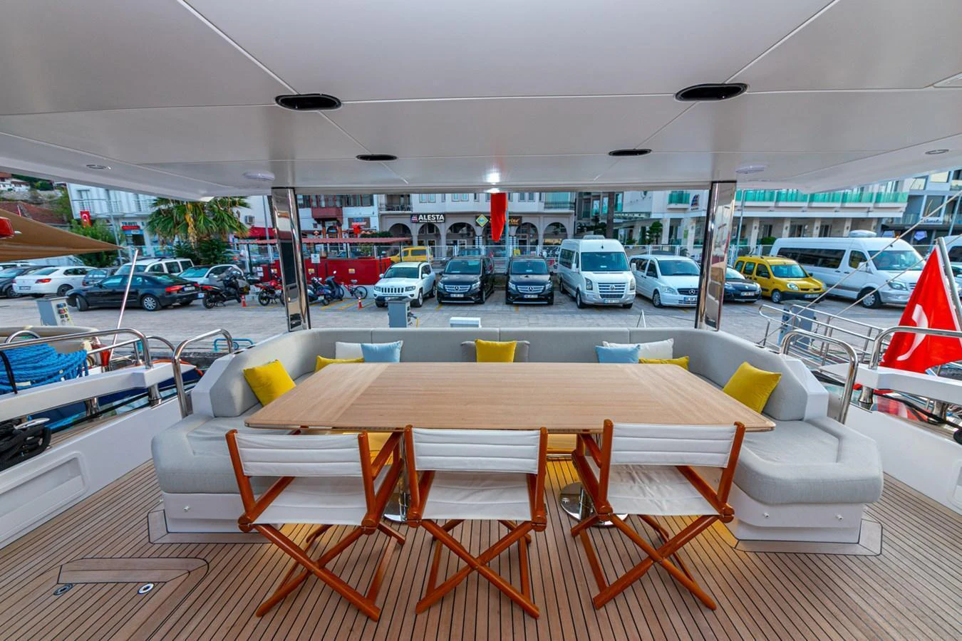 The aft deck features a spacious dining area with comfortable seating and a large table, perfect for alfresco meals. aboard NIRVANA BY THE SEA Yacht for Sale