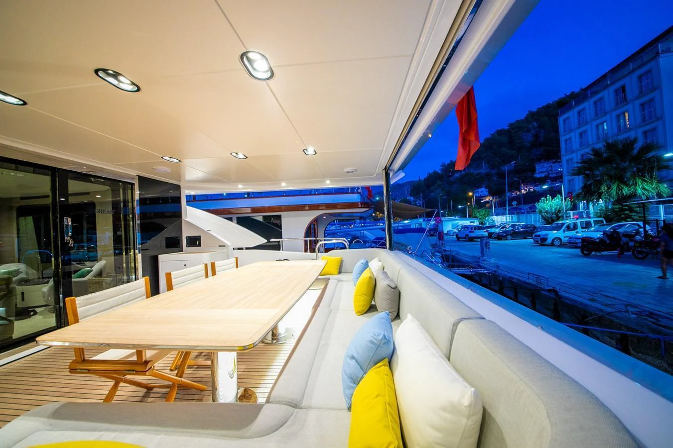 The aft deck features a spacious seating area with a large dining table, perfect for alfresco dining. aboard NIRVANA BY THE SEA Yacht for Sale
